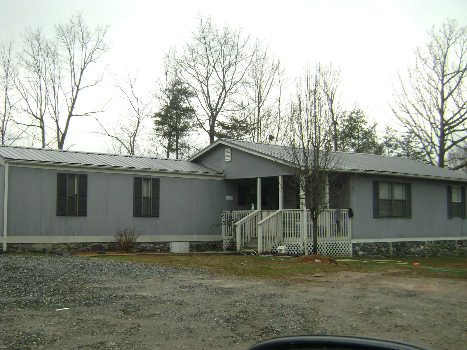 Metal roof over a manufactured home with a covered front porch in Herndon